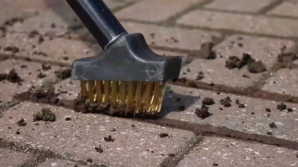 Cleaning grout with a stiff bristle brush